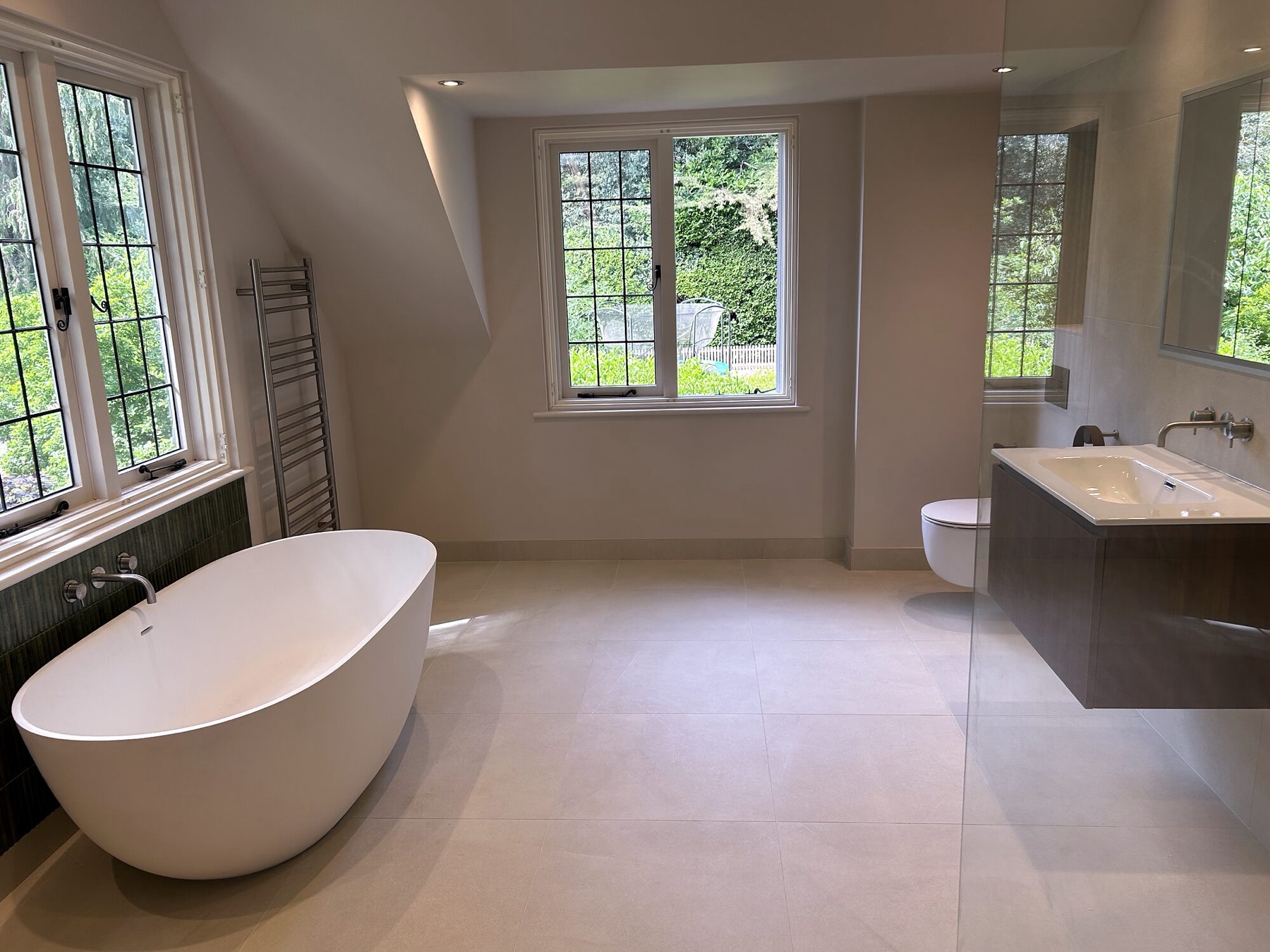 Large master bathroom with a freestanding bath, double vanity and leaded windows.